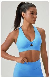 Close-up of sky blue yoga bra with front twist hollow detail and wide shoulder straps