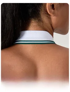 Detailed view of the halter neck design with green striped trim on white ribbed knit fabric