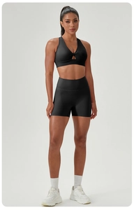 Detail of black cross-back yoga bra and high-waisted shorts with fast-dry fabric