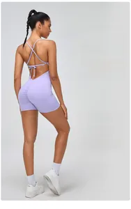 Detail of ruched purple yoga bodysuit with criss-cross back straps and V-shaped waist
