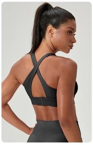 Close-up of X-back sports bra featuring adjustable hook-and-eye back closure details