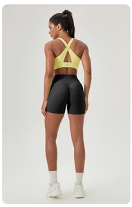Detail showing high-waisted scrunch butt gym shorts and cross-back sports bra design