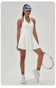 Detail of white tennis dress showing pleated A-line skirt and contrast polo collar
