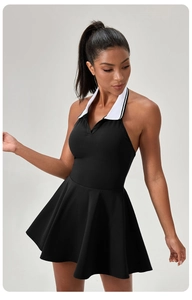 Detail of a black tennis dress featuring a white contrast polo collar and halter neck style