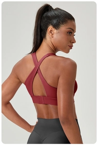 Detail view of burgundy cross-back sports bra with adjustable three-row hook closure
