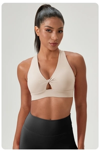 Detail of light beige yoga bra with V-neck twist design and breathable front cutout