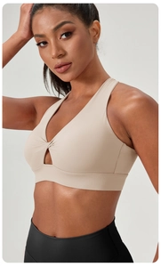 Detail of cross-front twist design and subtle cutout on high-stretch sports bra