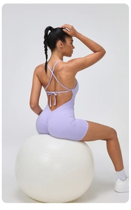 Detail of light purple backless yoga bodysuit with lace-up straps and ruched scrunch butt