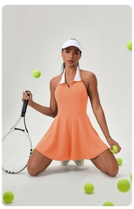 Detail of orange tennis dress showing white halter polo neck with contrast stripe pattern