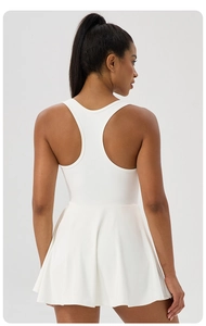 Rear view of white sleeveless tennis dress with racerback design and pleated skirt detail