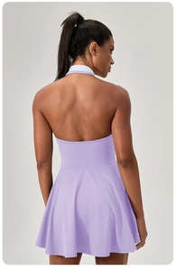 Detail of purple backless tennis dress with white striped collar and pleated skirt