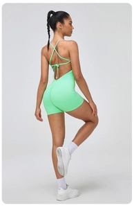 Close-up of fluorescent green bodysuit featuring criss-cross back straps and ruched details