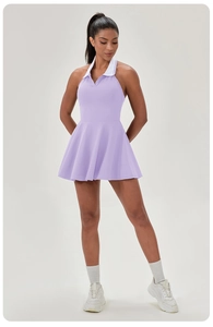 Detail of light purple tennis dress featuring a white halter collar and A-line pleated skirt