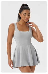 Detail of light grey athletic tennis dress with square neck and racerback pleated design