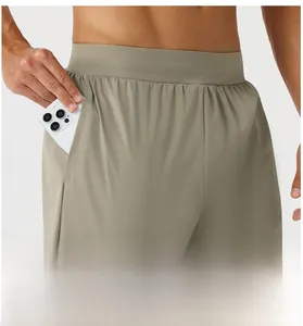Detail of khaki quick-dry athletic pants showing deep side pockets for phone storage