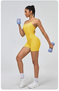 Close-up of vibrant yellow backless yoga bodysuit with thin straps and elastic fabric