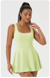 Detail view of lime green athletic dress with square neck and wide shoulder straps