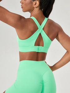 Mint green high-impact yoga set with cross-back sports bra and ruched leggings