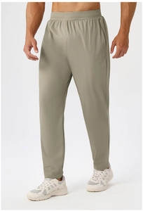 Detail of olive green athletic pants featuring an elastic drawstring waist and premium fabric