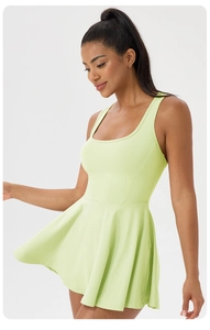 Detailed side view of a light green sleeveless athletic dress with pleated hem for tennis