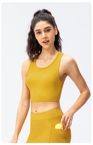 Detail of yellow ribbed yoga vest with high elasticity and side pocket for tennis balls