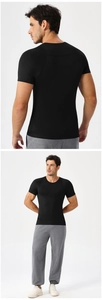 Detail of men's black slim fit gym t-shirt with raglan sleeves and breathable fabric