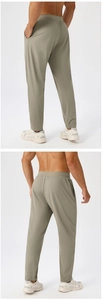 Detail view of olive green quick-dry men's athletic joggers with elastic waist and pockets