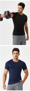 Close-up of black and navy men's compression shirts showing muscle-fit fabric texture