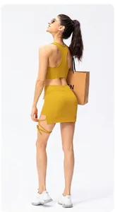 Detail view of mustard yellow ribbed yoga set with racerback top and side slit mini skirt