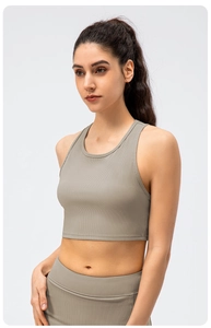 Detail of taupe ribbed high-elastic yoga tank top and matching leggings for fitness