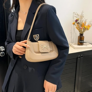 Beige minimalist shoulder bag for women with elegant gold bow metal buckle detail