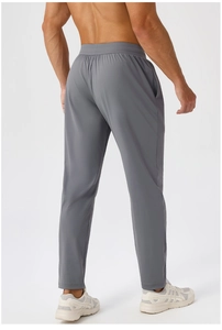 Rear view of men's quick-dry sports trousers in dark grey with elastic waistband