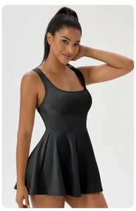 Detailed front view of the square neck and flared hem on a black athletic tennis dress