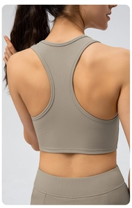 Rear view of a taupe ribbed racerback yoga tank top showing elastic fit and fabric texture