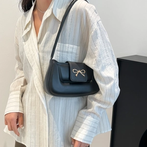 Minimalist black leather shoulder bag with a stylish golden bow buckle for women