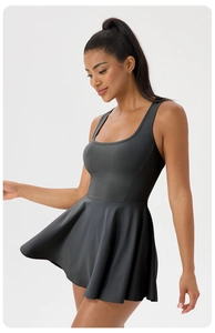 Detail view of the racerback design and pleated hem on this dark gray athletic tennis dress