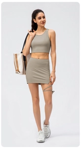 Detail of ribbed yoga tank top and mini skirt with stylish leg cross-strap design