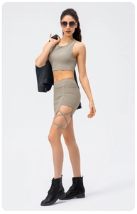 Detail of ribbed knit texture on khaki green two-piece yoga set with lace-up skirt