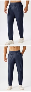 Detail of dark blue men's quick-dry sports pants with elastic waistband and tapered leg