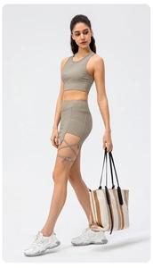 Detail of greyish-green ribbed yoga top and shorts with trendy side cutout lace-up design