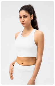 Close-up of white ribbed yoga set showing fine vertical texture and high-elasticity fabric