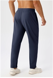 Detail view of elastic waistband and breathable fabric on navy blue men's joggers