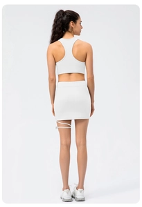 Rear view of white ribbed yoga set with racerback top and side strap skirt detail