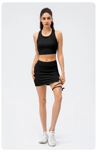 Detail shot of black ribbed yoga top and skirt set with thigh wrap bandage ties