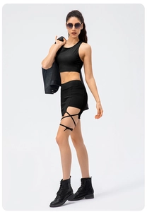 Full body studio shot of a ribbed black sports vest and cutout skirt with lace-up detail