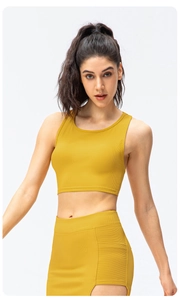 Detail of mustard yellow ribbed yoga set showing cropped tank top and side hollow-out leggings
