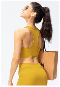 Detail view of ginger yellow ribbed yoga set showing crossback bra and high waist leggings
