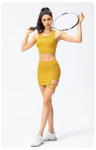 Detail of yellow ribbed yoga set with side lace-up cutout skirt and sleeveless crop top