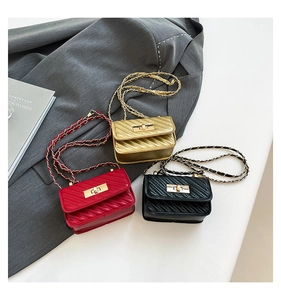 Three mini crossbody chain bags with V-shaped quilting in gold, red, and black finish