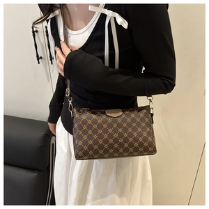 Model view of brown vintage monogram crossbody bag in PU leather with gold hardware